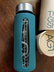 AG1 The Glass Shaker 16 fl oz Glass Bottle Green Sleeve Screw-On Lid, Marks